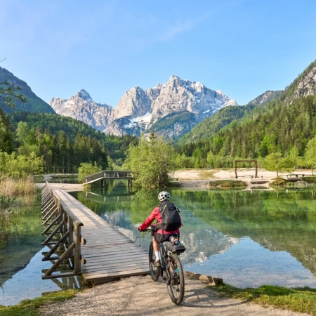 A man Cycling over a bridge near Jasna Lake in Slovenia